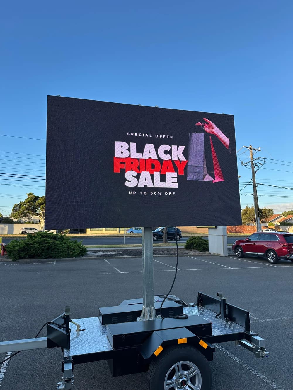 LED trailer sign displaying a full-colour 'Black Friday Sale' retail promotion with a shopping-bag graphic